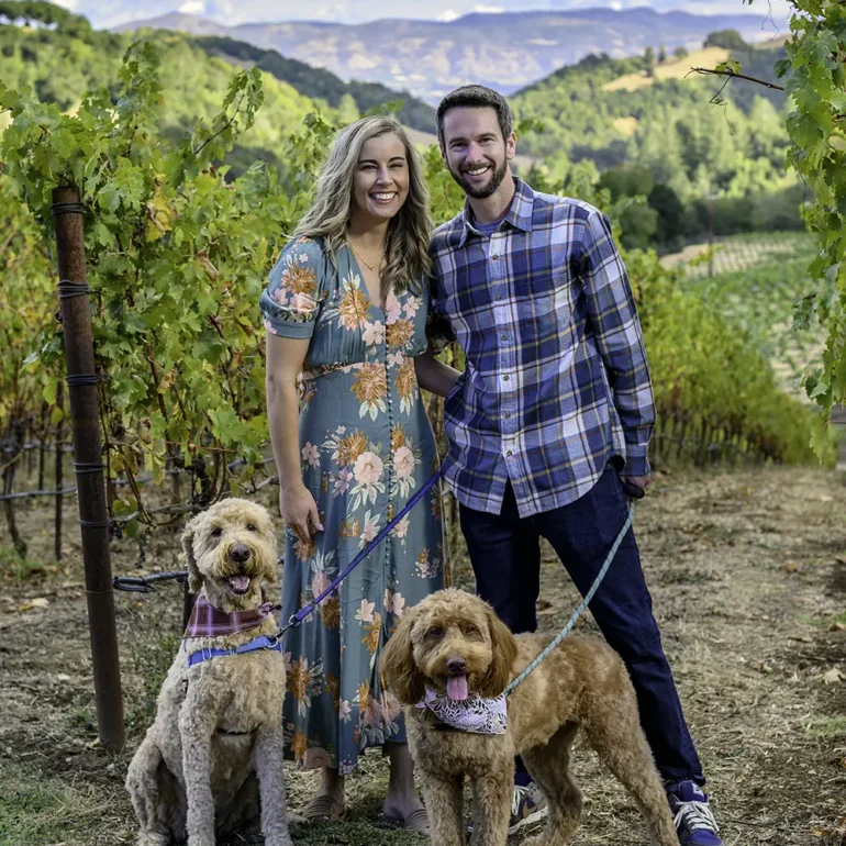 Couple and their dogs posing for family photographer in Napa Valley