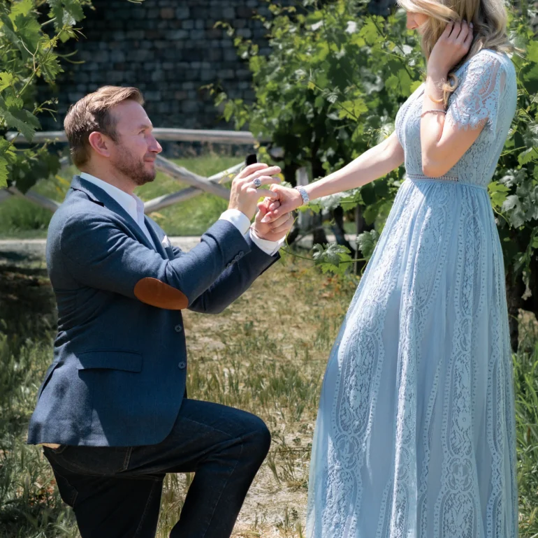 Couple posing for photographer in Santa Rosa during proposal in a vineyard