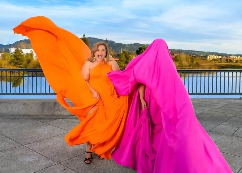 Two women experiencing the Flying Dress photoshoot in Downtown Napa