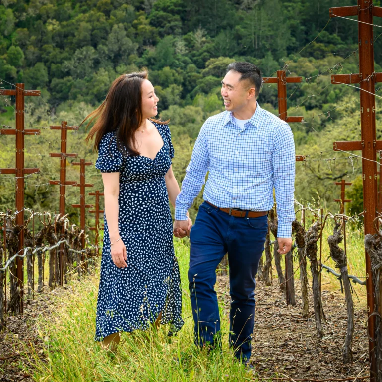 napa winery proposal photographer couple walking in vineyard